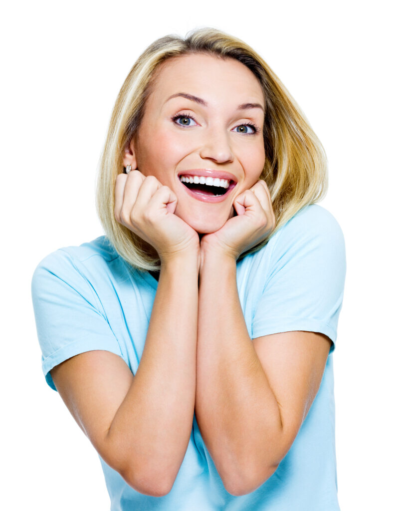 Woman with a large smile holding her hands to her face in excitement