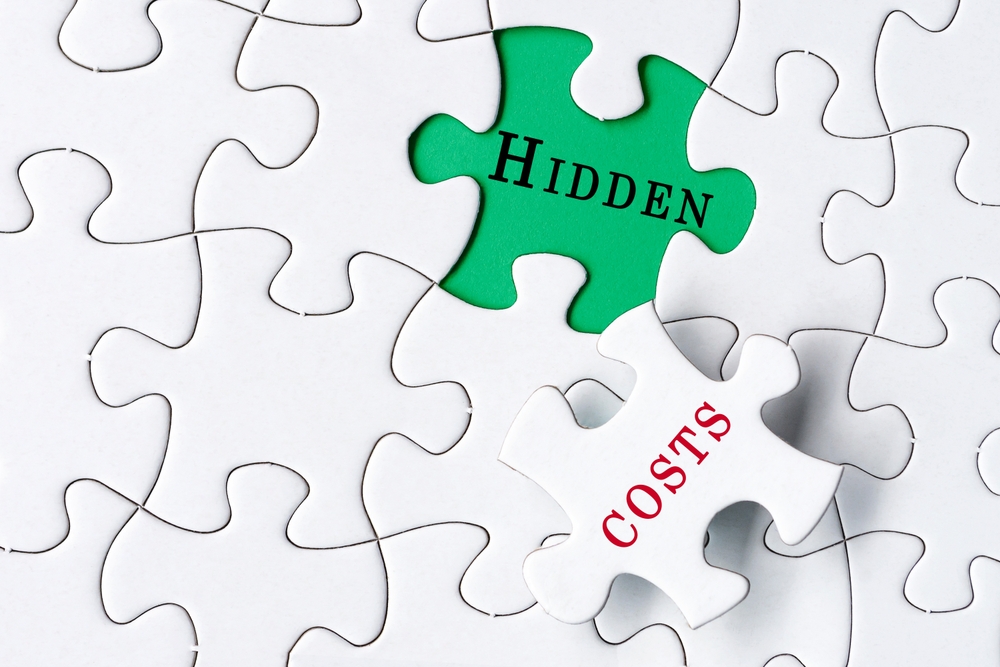 A jigsaw puzzle showing the words "Hidden" and "Costs"