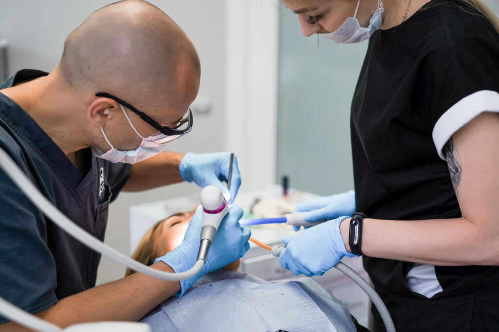 A dentist and dental assistant working on a patient