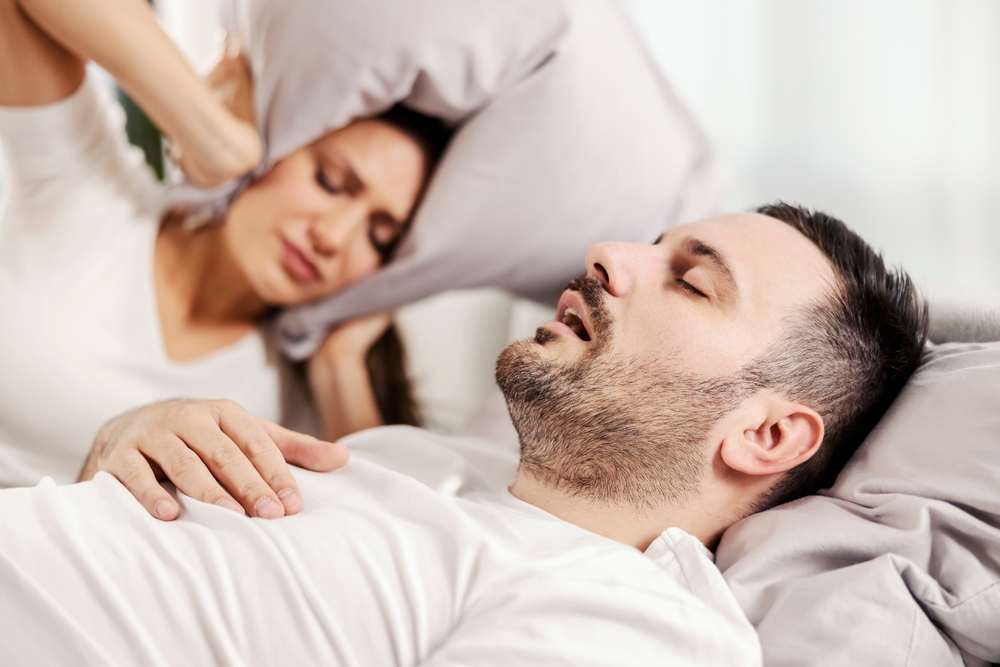 A man with UARS snores as his partner covers her ears