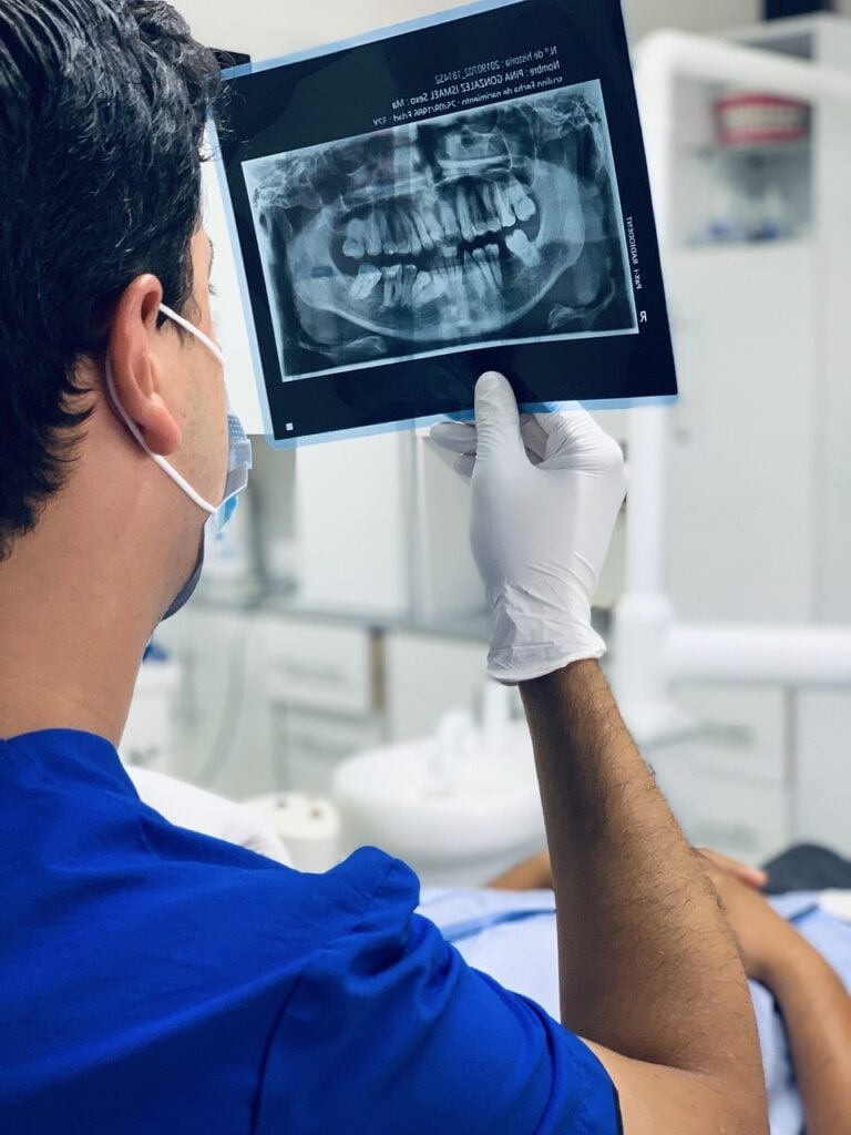 Dentist examining a dental X-ray in a clinic.