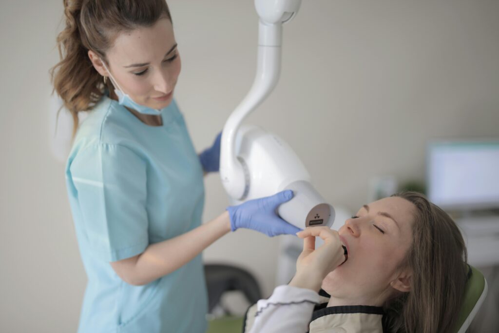 Dentist performing an oral examination on a patient.