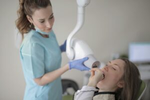 Dentist performing an oral examination on a patient.