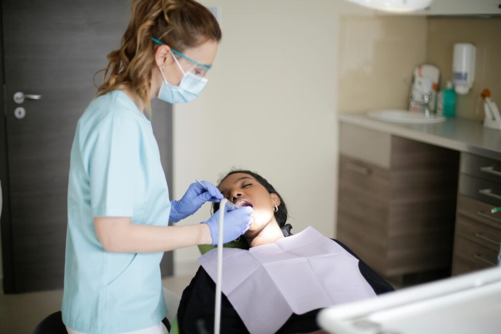 Dentist examining an adult patient in a dental office.