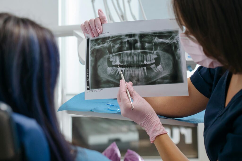 Dentist showing a dental X-ray to a patient during a checkup.