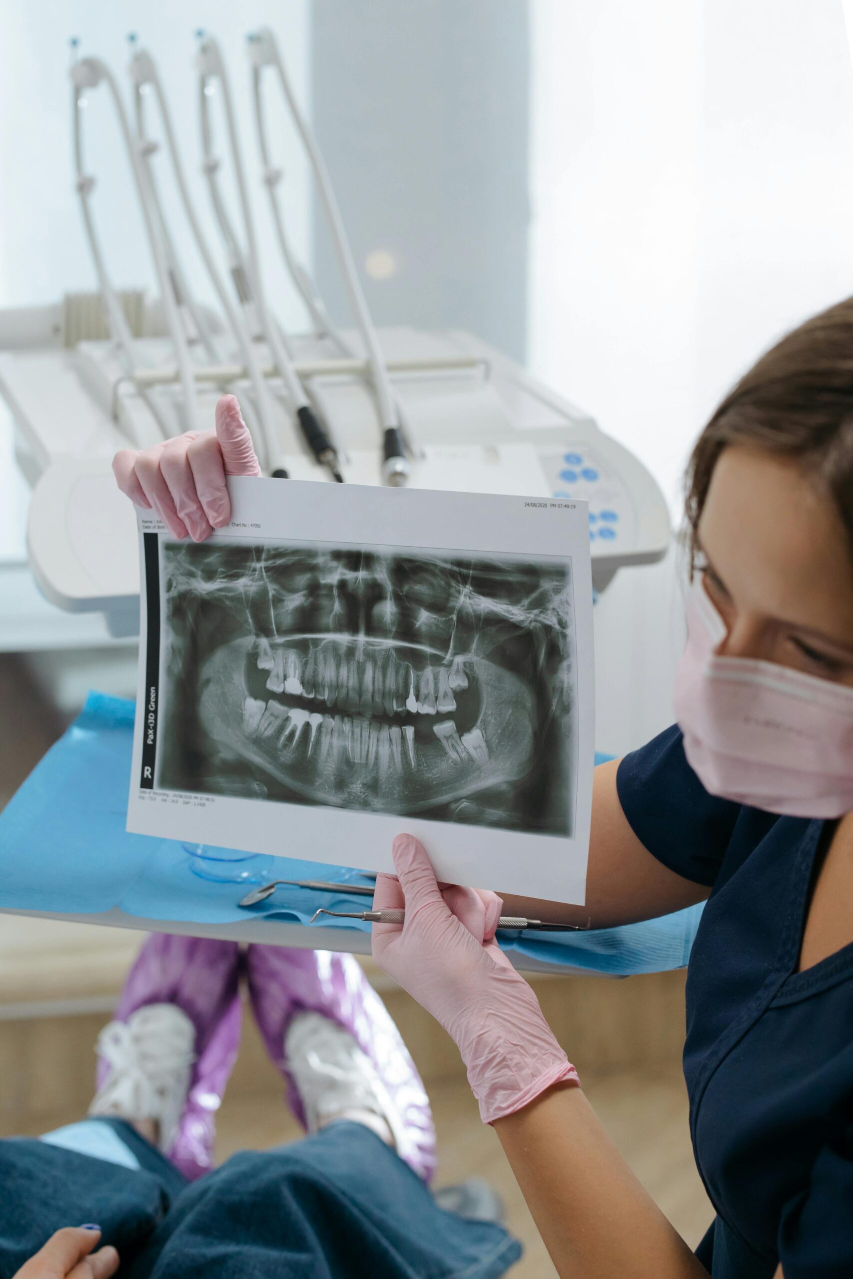 Dentist showing a dental X-ray to a patient.