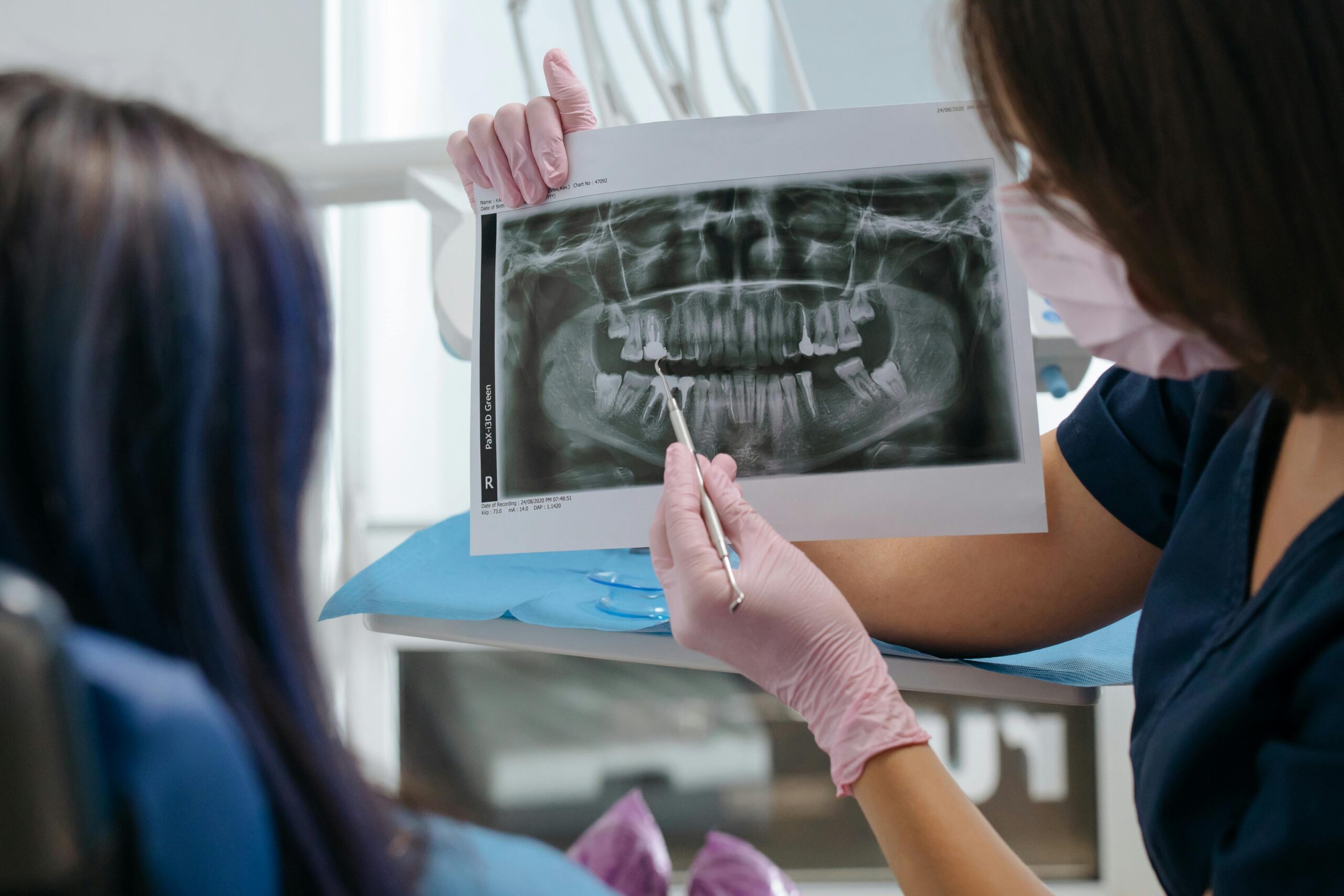 Dentist showing a dental X-ray to a patient.