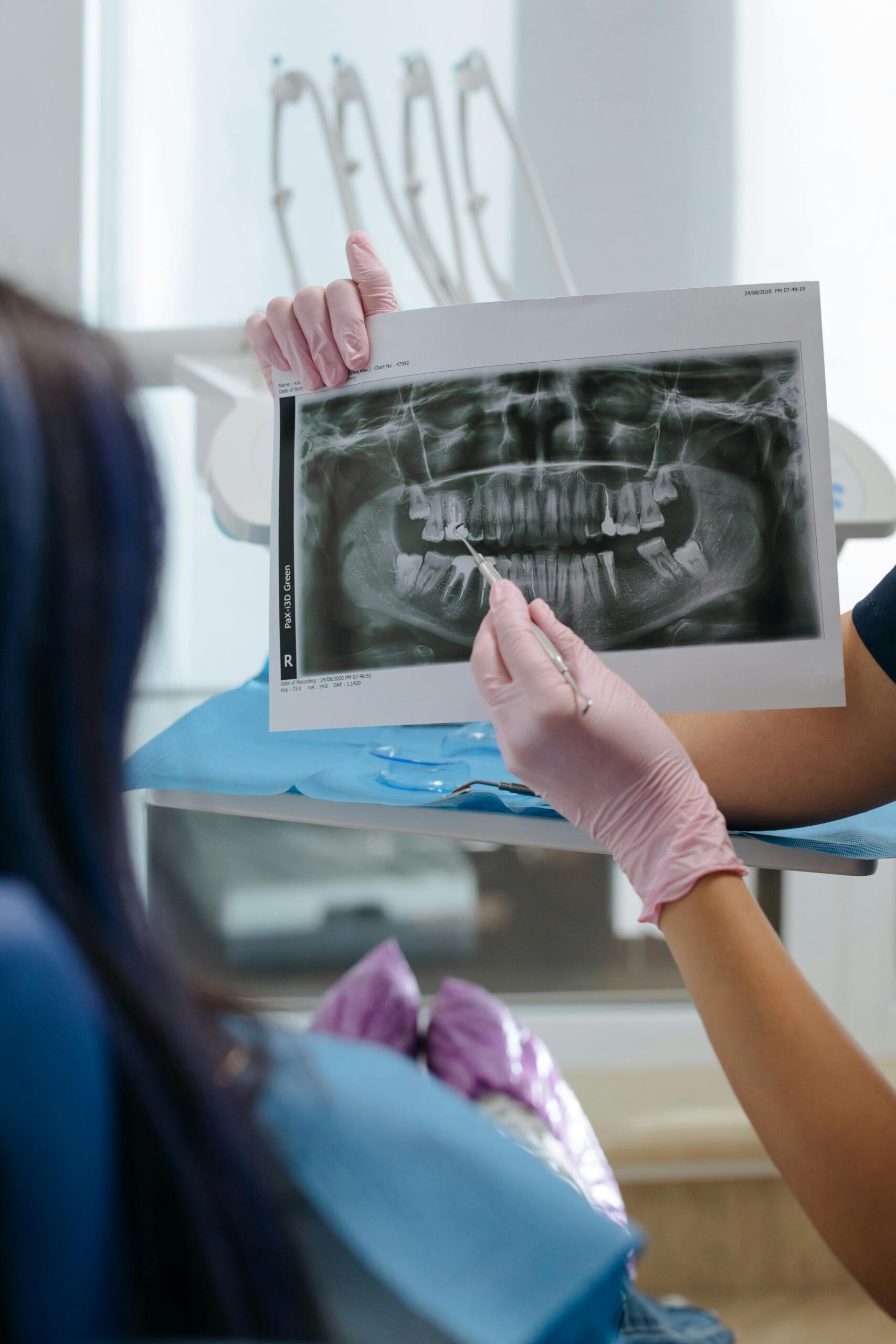 Dentist showing a dental X-ray to a patient.