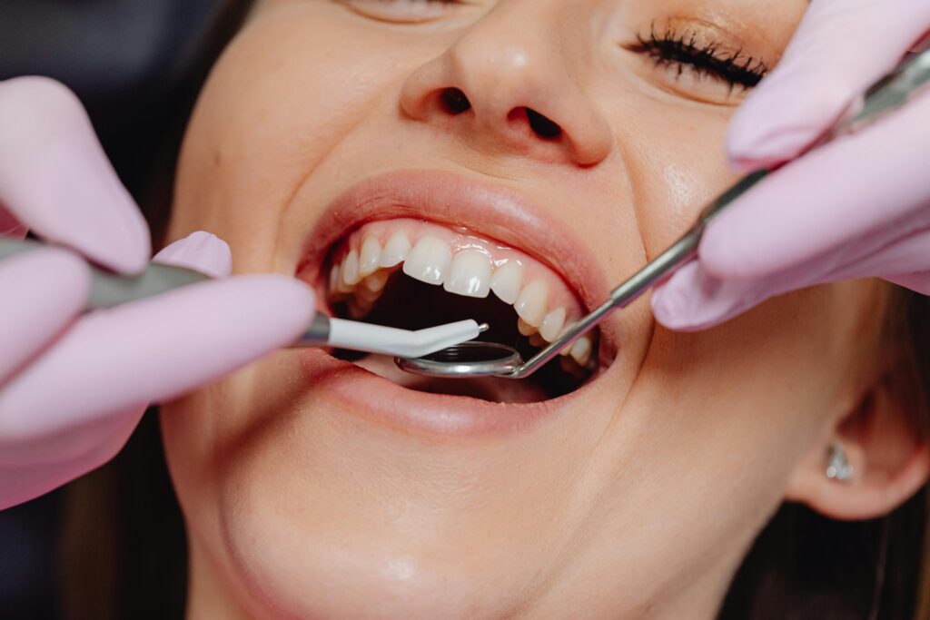 Dentist performing deep cleaning on a patient's teeth.