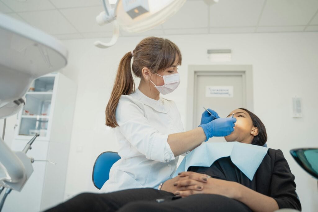 Dentist examining a patient for tooth abscess symptoms.