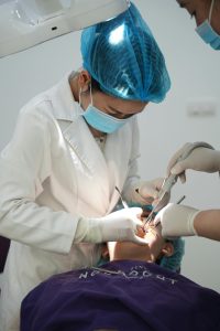 Dentist performing a procedure on a patient in a clinic.
