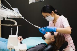 Dentist performing a procedure on a patient under deep sedation.